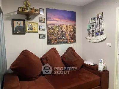 Cozy living room with plush brown sofa and cityscape wall art, perfect for relaxation.