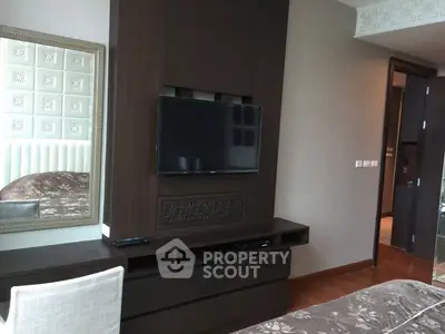 Luxurious bedroom with modern TV setup and elegant decor