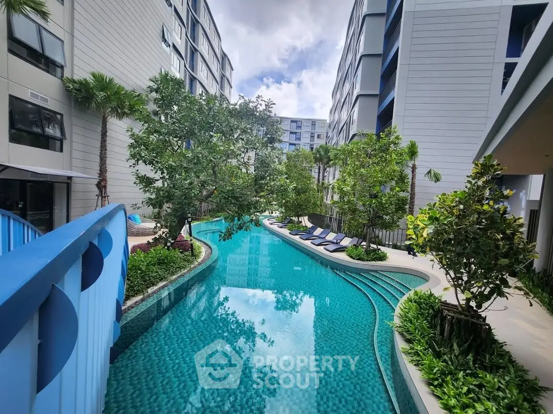 Luxurious residential complex with stunning pool and lush greenery