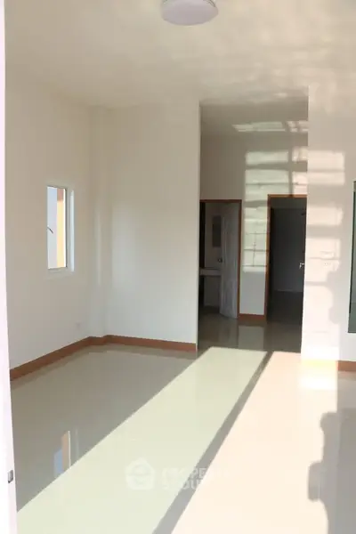 Bright and spacious room with glossy tiled floors and natural light