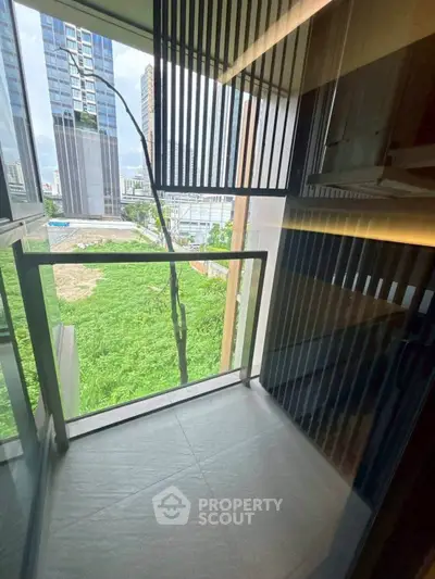 Modern balcony with city view and sleek railing design in urban high-rise apartment.