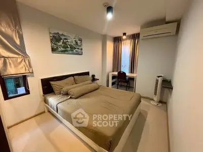 Cozy bedroom with modern decor and air conditioning in a stylish apartment.