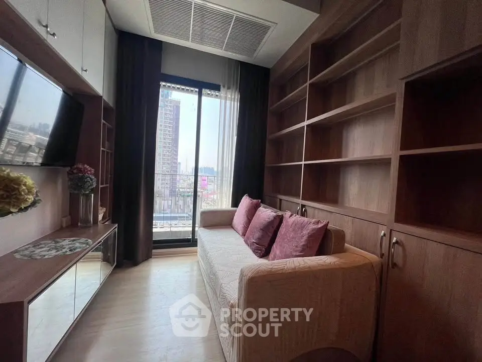 Chic living room with built-in shelves and city view balcony in modern apartment.