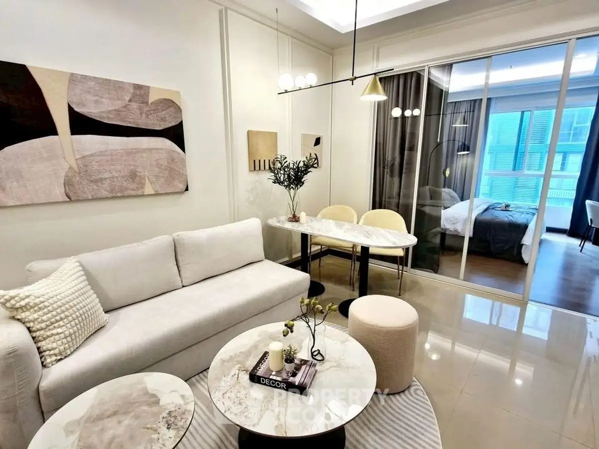 Modern living room with elegant decor and open view to bedroom