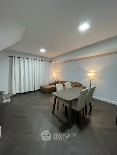 Spacious modern living room with elegant dining area and cozy lighting