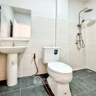 Modern bathroom with white subway tiles and sleek fixtures