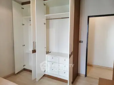 Spacious bedroom with open wardrobe and modern design