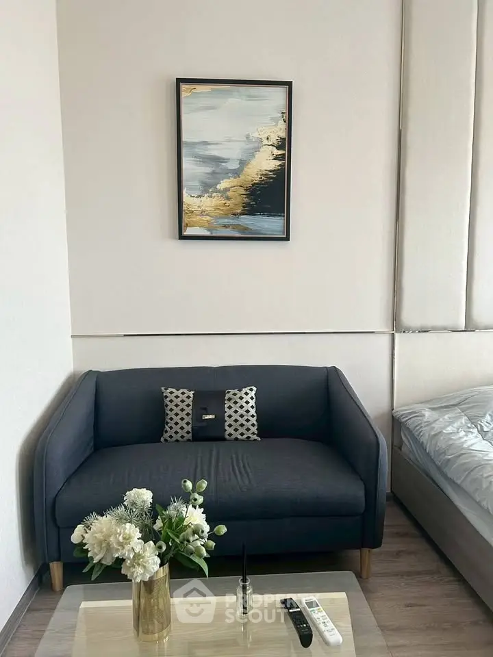 Modern living room with stylish sofa, elegant decor, and cozy ambiance.