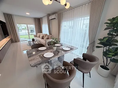 Elegant open-plan living and dining area with modern decor and large windows.