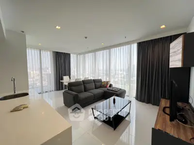 Spacious modern living room with panoramic city views and elegant furnishings.