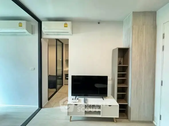 Modern living room with sleek TV stand and air conditioning in stylish apartment.