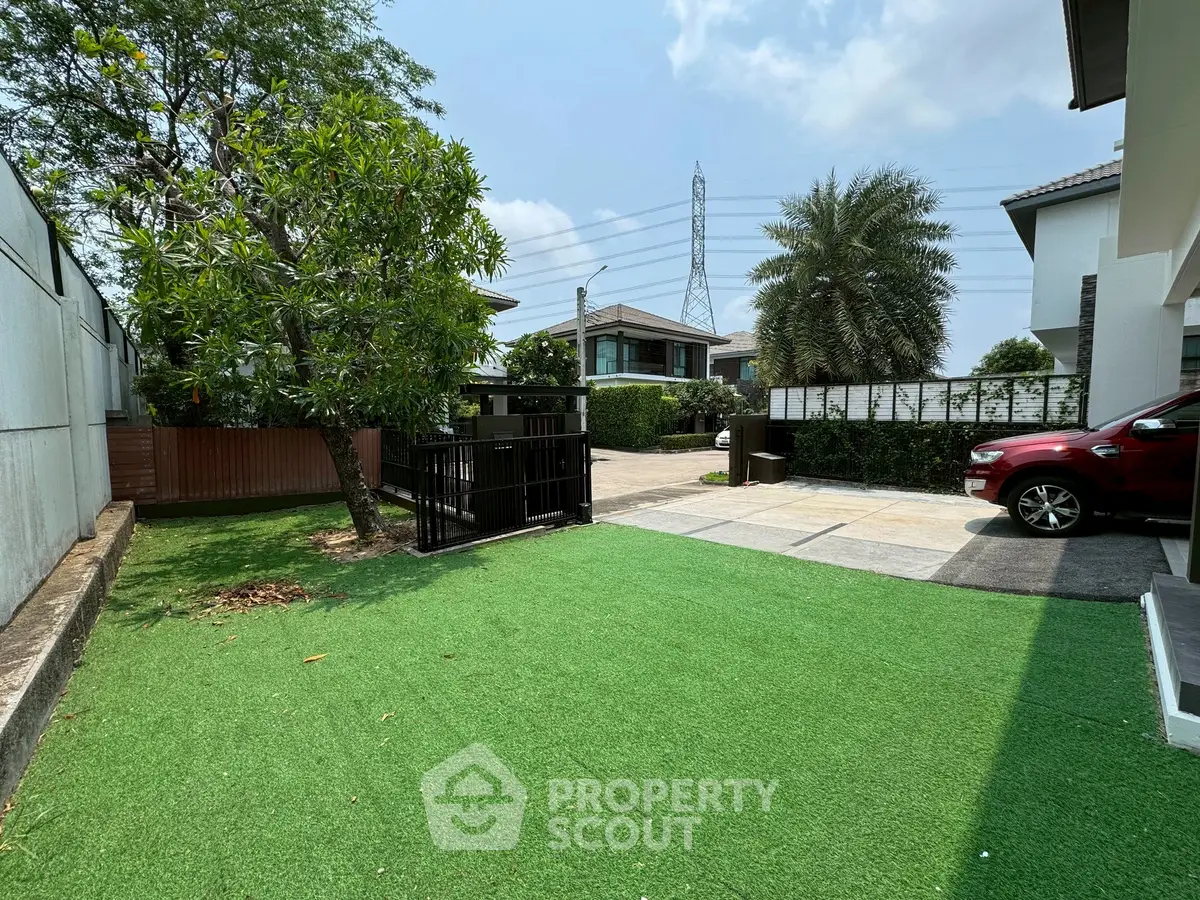 Spacious residential property with lush garden and modern driveway in a serene neighborhood.