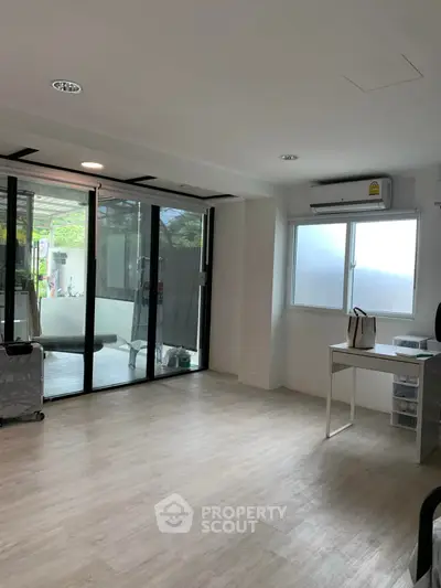 Spacious modern living room with large windows and sleek flooring