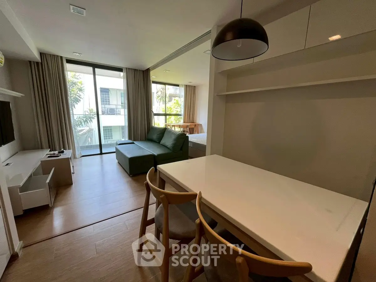 Modern living room with large windows and stylish furniture in a contemporary apartment.