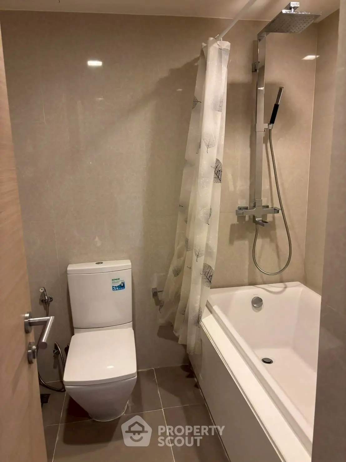 Modern bathroom with sleek bathtub and shower in elegant design.