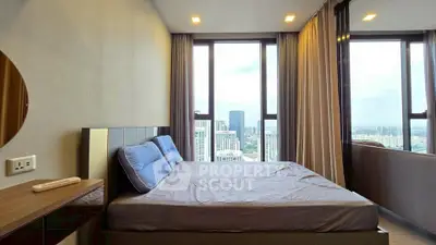 Modern bedroom with city view, featuring large windows and stylish decor in a high-rise apartment.