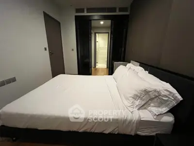 Spacious bedroom with modern design and cozy ambiance, featuring a comfortable bed and stylish decor.