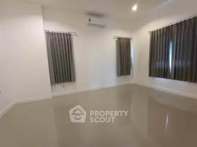 Spacious empty room with glossy floor and air conditioning, ready for customization.