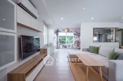 Spacious modern living room with stylish decor and large windows for natural light.