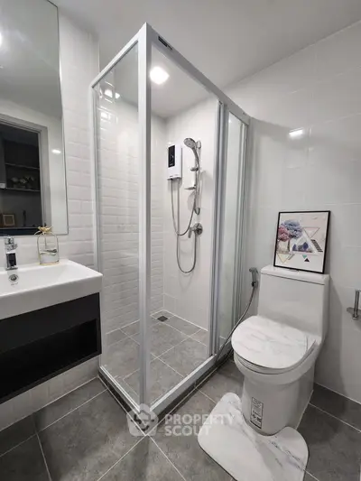 Modern bathroom with glass shower enclosure and sleek fixtures