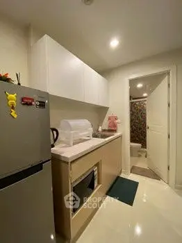 Compact kitchen with modern appliances and sleek cabinetry