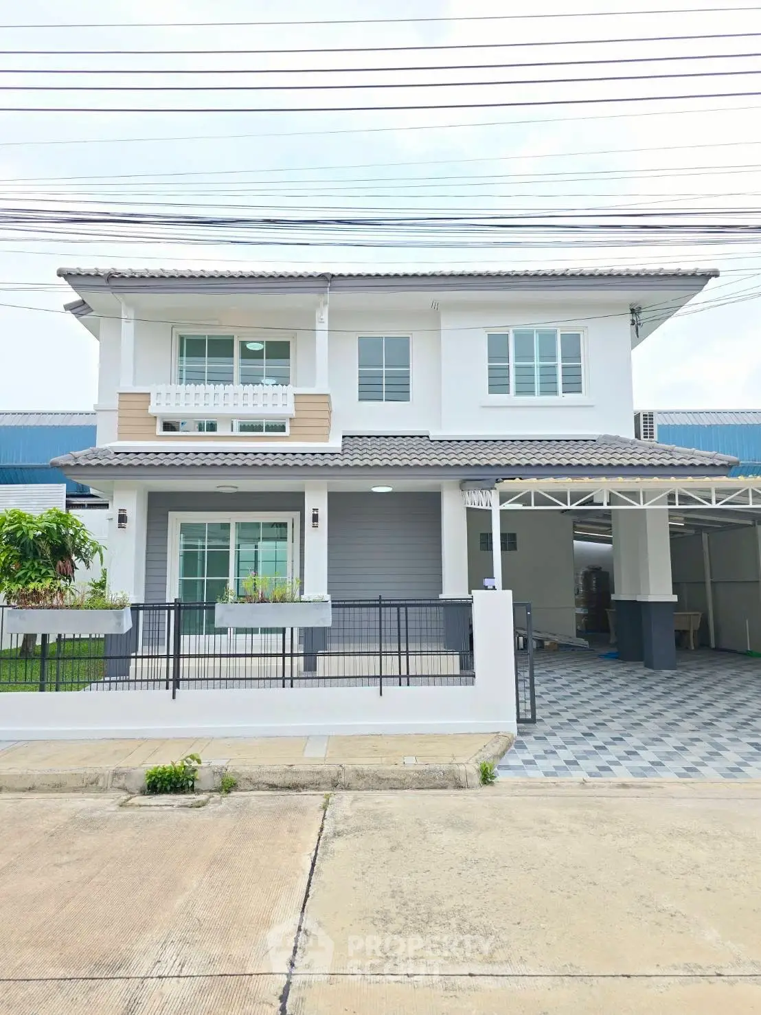 Modern two-story house with spacious driveway and contemporary design.