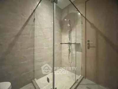 Modern bathroom with glass shower enclosure and sleek fixtures