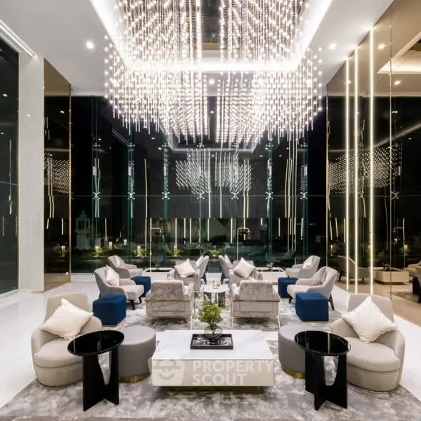Luxurious modern living room with stunning chandelier and elegant seating area.