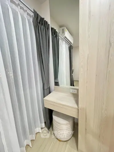 Modern bedroom corner with stylish vanity and elegant curtains