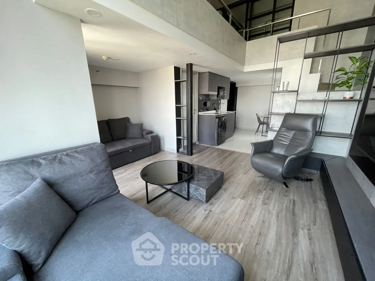 Modern living room with stylish furniture and open layout, featuring sleek design and natural light.