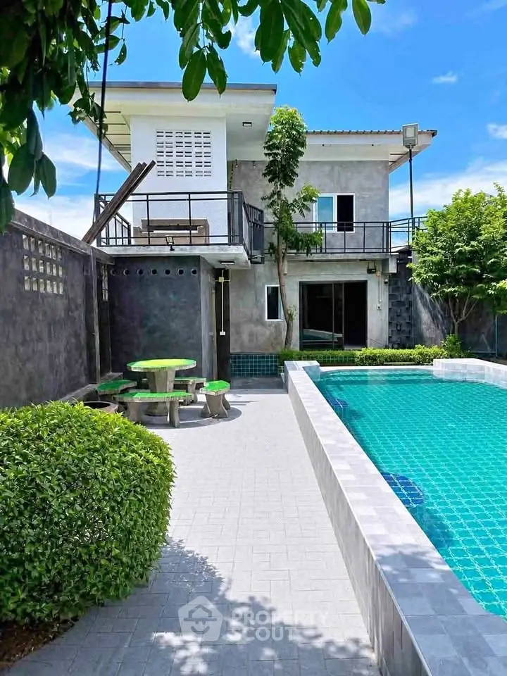 Modern two-story home with private pool and lush garden, perfect for luxury living.