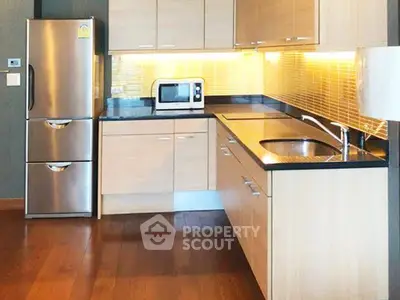 Modern kitchen with stainless steel fridge and sleek cabinetry