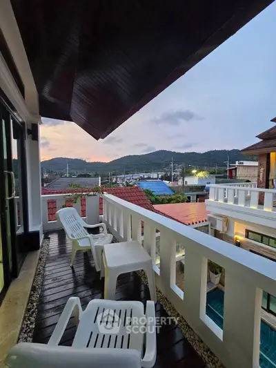 Charming balcony with mountain views and cozy seating, perfect for relaxation.