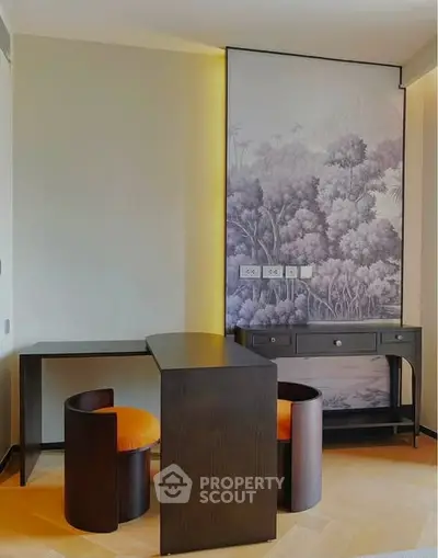Stylish study area with modern desk and chairs, featuring elegant wall art and warm lighting.