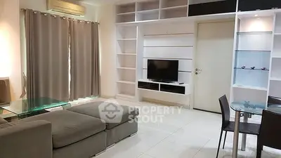 Spacious modern living room with sleek furniture and built-in shelving.