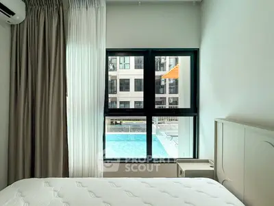 Bright bedroom with pool view in modern apartment