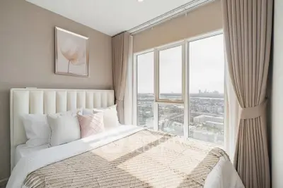Luxurious bedroom with panoramic city view and elegant decor