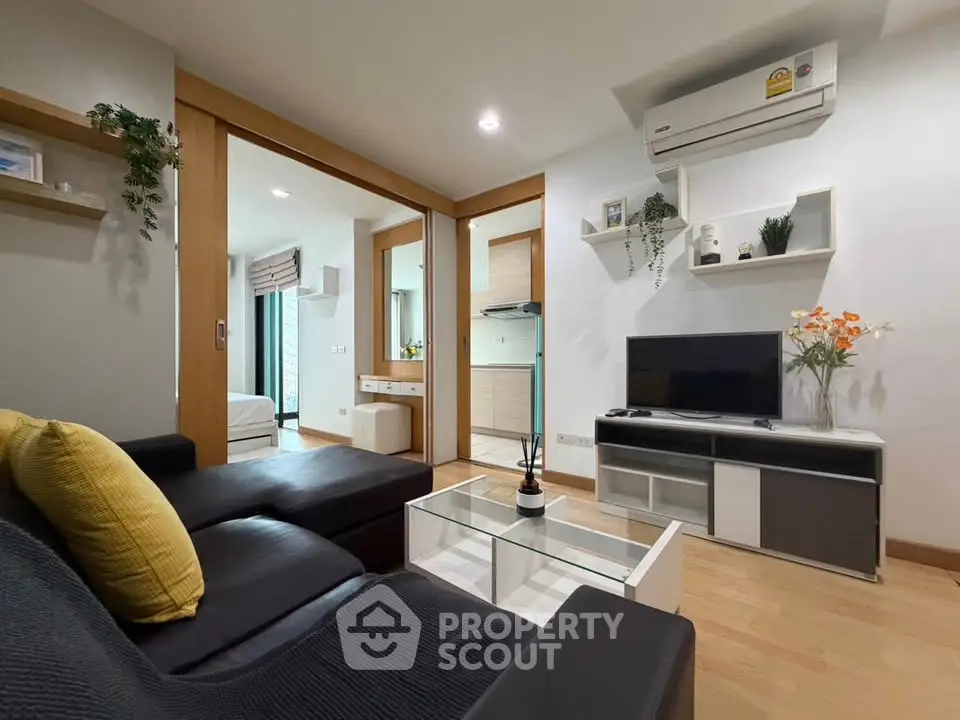 Modern living room with sleek furniture and open layout in a stylish apartment.