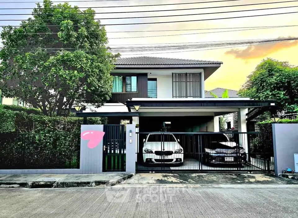Charming two-story house with modern design and spacious driveway in a serene neighborhood.