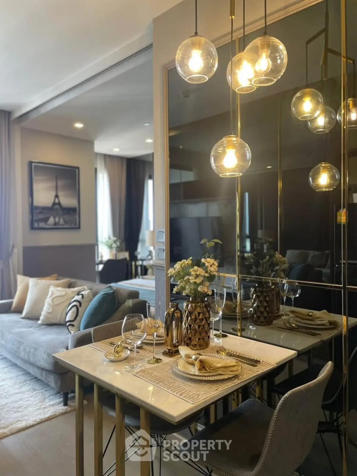 Elegant modern living room with dining area, stylish lighting, and cozy decor in a luxurious apartment.