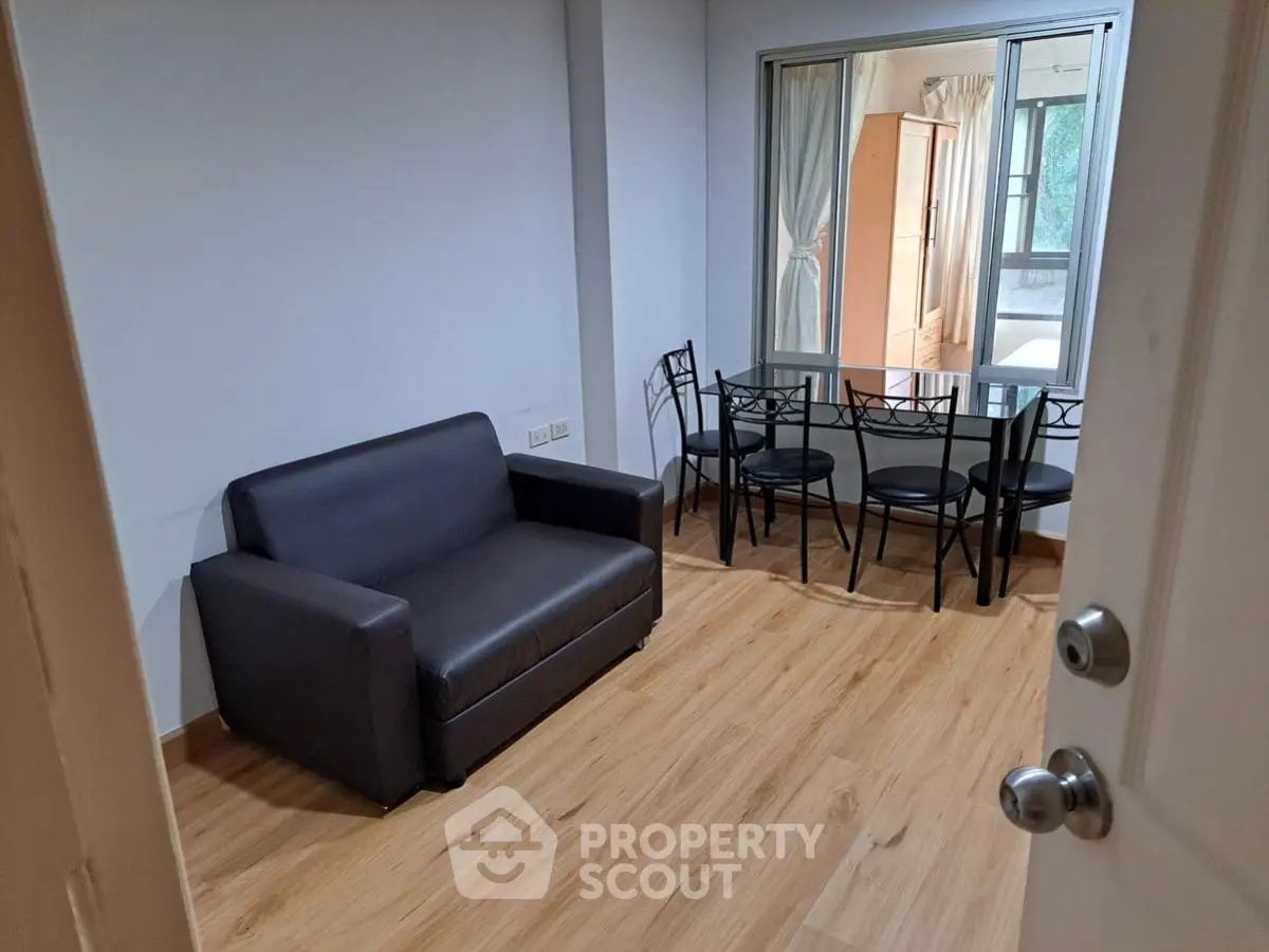 Cozy living room with modern sofa and dining set, perfect for urban living.