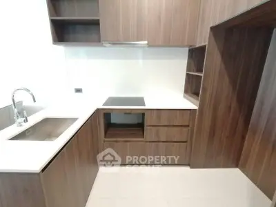 Modern kitchen with sleek wooden cabinetry and integrated appliances