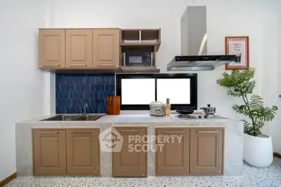 Modern kitchen with sleek cabinetry and stylish backsplash, featuring stainless steel appliances and a cozy dining area.