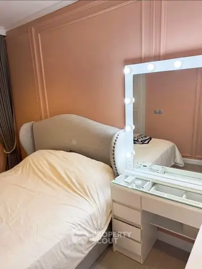 Chic bedroom with elegant vanity and upholstered headboard, perfect for modern living.