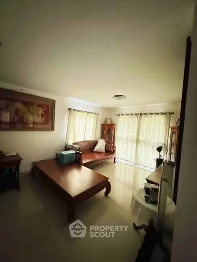 Spacious living room with elegant furniture and large windows for natural light.
