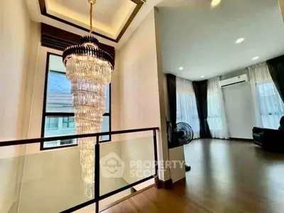 Elegant interior with stunning chandelier and spacious living area, perfect for luxury living.