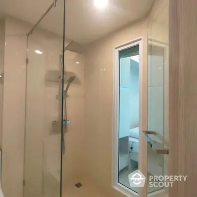 Modern bathroom with glass shower enclosure and sleek fixtures