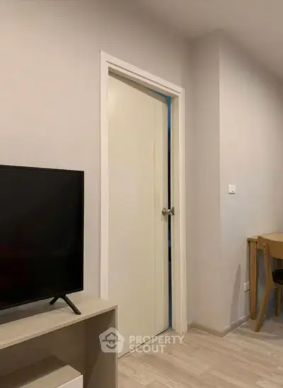 Modern living room with sleek TV stand and wooden furniture, perfect for cozy evenings.