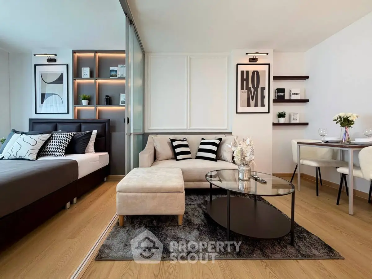 Modern studio apartment with stylish decor, featuring a cozy living area and elegant dining space.