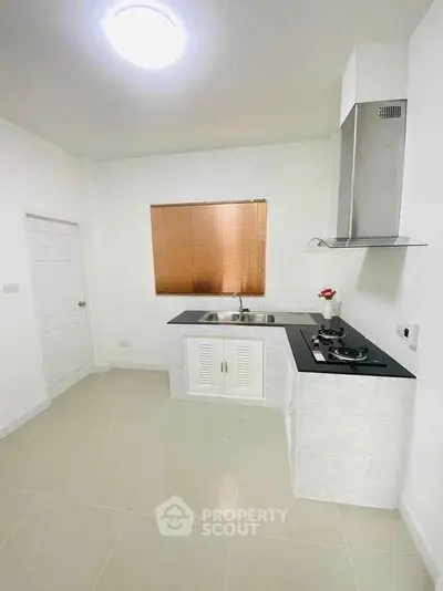 Modern kitchen with sleek design, featuring a gas stove and ample counter space.